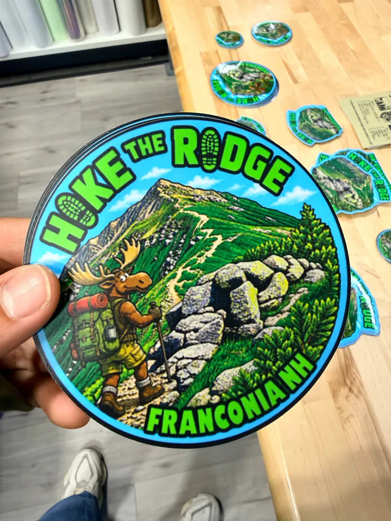 Hike the ridge round die cut sticker in hand