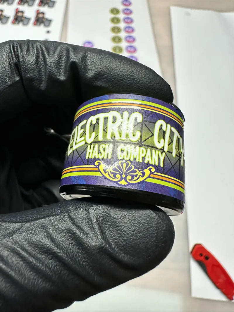 Electric city hash labeled jar in glove