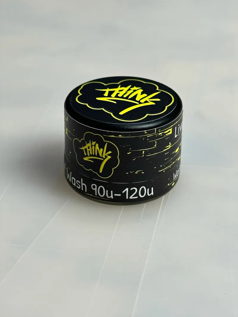 Thicc black jar with yellow foil label on cl
