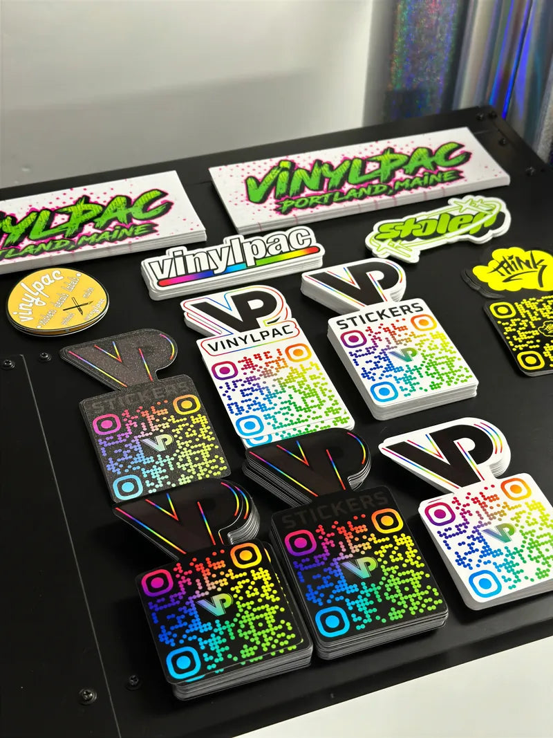 VINYLPAC flat lay of VINYLPAC holo qr and sl